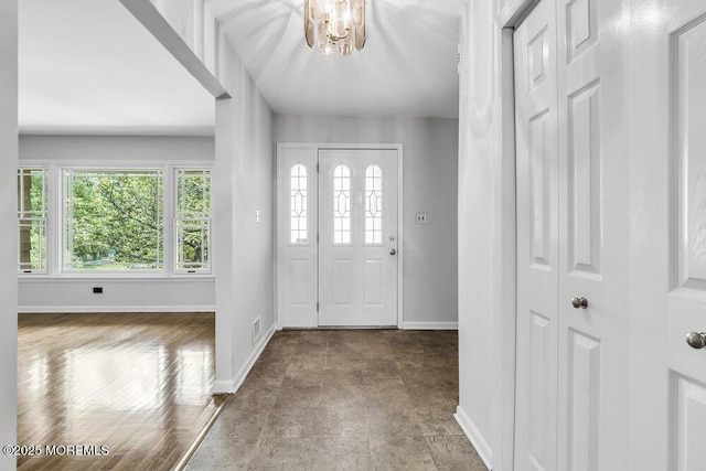 25 Overhill Rd, Ocean Twp, NJ 07712 - entrance foyer with baseboards and a chandelier