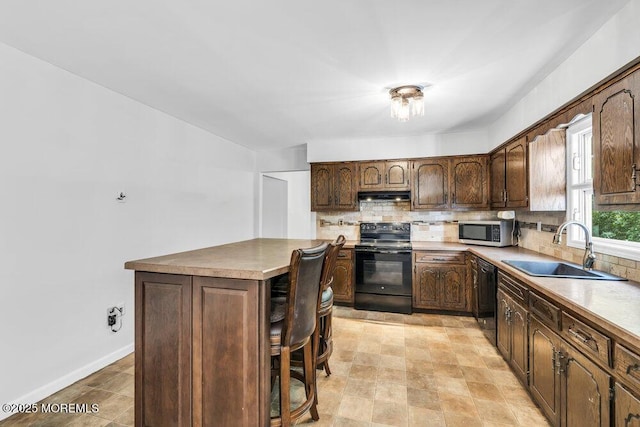 25 Overhill Rd, Ocean Twp, NJ 07712 - kitchen with black appliances, a sink, tasteful backsplash, and under cabinet range hood