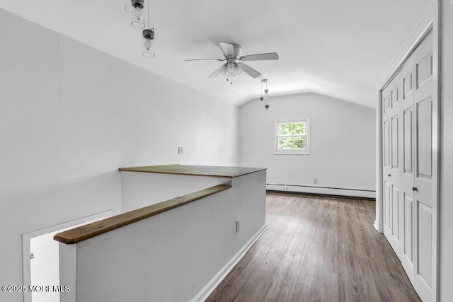 25 Overhill Rd, Ocean Twp, NJ 07712 - corridor with vaulted ceiling, baseboard heating, wood finished floors, and baseboards