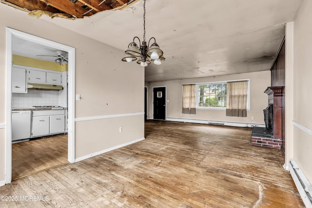 812 Donna Dr, Point Pleasant, NJ 08742 - unfurnished living room featuring a baseboard radiator, wood finished floors, ceiling fan, and a chandelier
