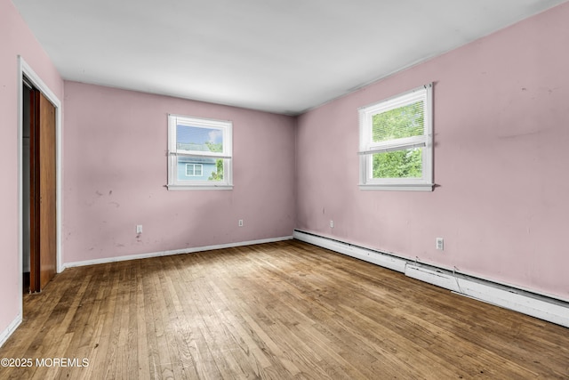 812 Donna Dr, Point Pleasant, NJ 08742 - unfurnished bedroom featuring a baseboard radiator, wood-type flooring, and baseboards