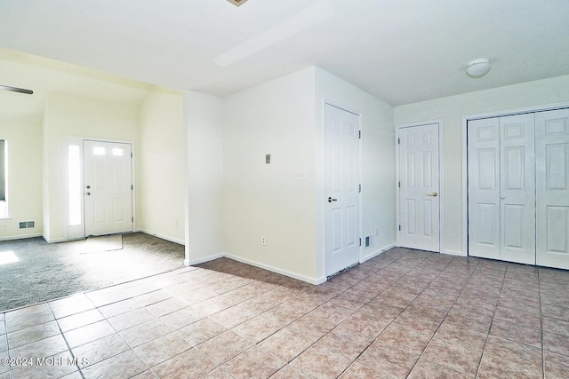 406 River Ter, Toms River, NJ 08755 - foyer entrance with light tile patterned floors, baseboards, and light carpet
