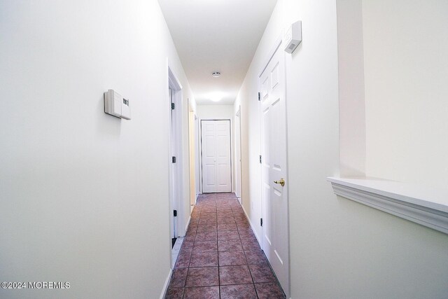 406 River Ter, Toms River, NJ 08755 - hallway featuring dark tile patterned floors and baseboards
