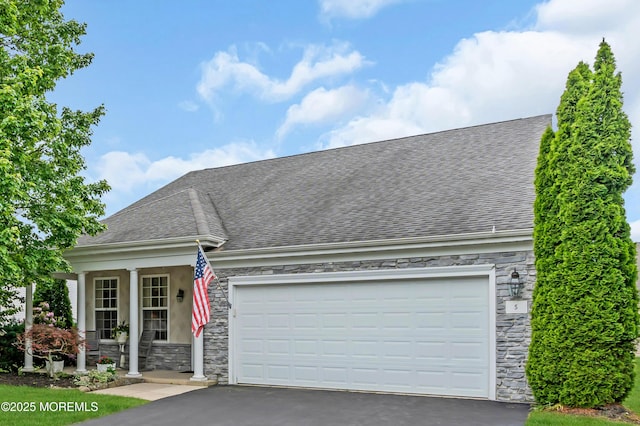 5 Minot Light Ct, Barnegat, NJ 08005 - view of front of home featuring stone siding, a shingled roof, asphalt driveway, covered porch, and an attached garage