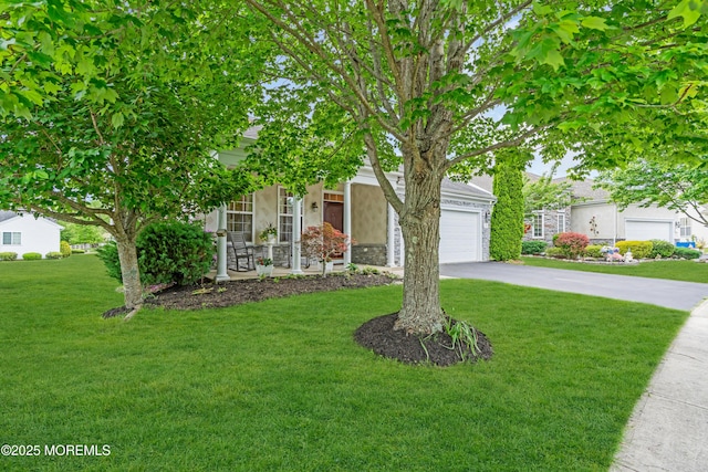 5 Minot Light Ct, Barnegat, NJ 08005 - view of property hidden behind natural elements with an attached garage, driveway, a front lawn, and stucco siding