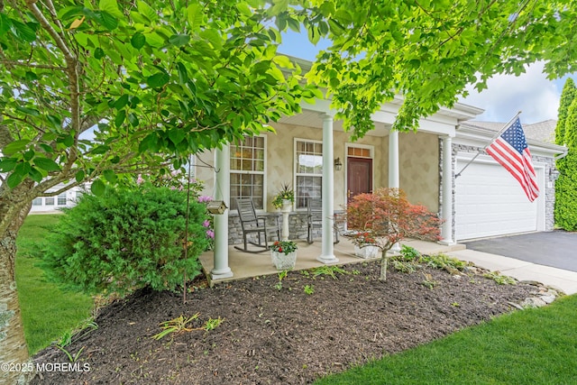 5 Minot Light Ct, Barnegat, NJ 08005 - view of front of home with covered porch, an attached garage, driveway, stone siding, and stucco siding