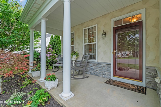 5 Minot Light Ct, Barnegat, NJ 08005 - property entrance with a porch, stone siding, and stucco siding