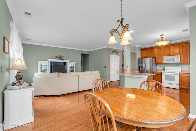 5 Minot Light Ct, Barnegat, NJ 08005 - dining area featuring ornamental molding, light wood-type flooring, and a chandelier