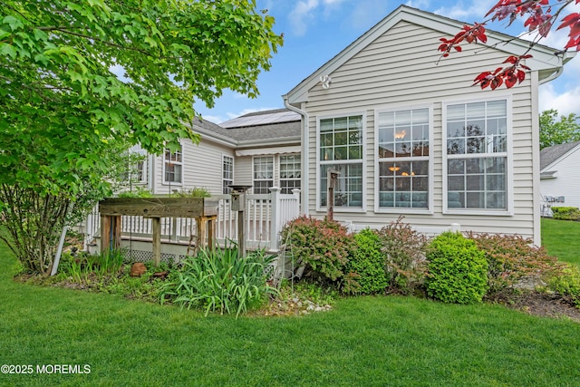 5 Minot Light Ct, Barnegat, NJ 08005 - rear view of property with roof mounted solar panels, a lawn, and a wooden deck