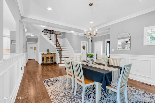 342 Old Squan Rd, Brick, NJ 08724 - dining space featuring stairway, crown molding, wood finished floors, a decorative wall, and a chandelier