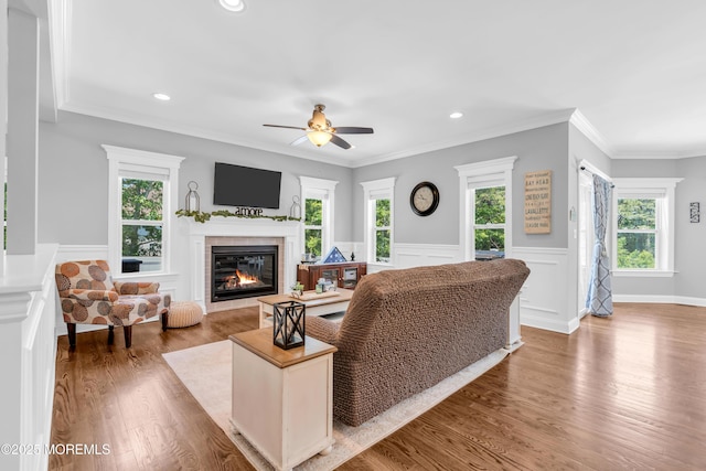342 Old Squan Rd, Brick, NJ 08724 - living area with a glass covered fireplace, wood finished floors, plenty of natural light, wainscoting, and recessed lighting