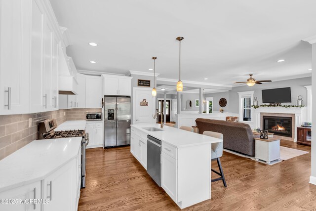 342 Old Squan Rd, Brick, NJ 08724 - kitchen featuring stainless steel appliances, a sink, ceiling fan, premium range hood, and a kitchen bar