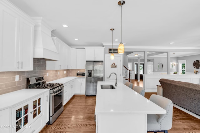 342 Old Squan Rd, Brick, NJ 08724 - kitchen featuring appliances with stainless steel finishes, a sink, a breakfast bar, an island with sink, and tasteful backsplash