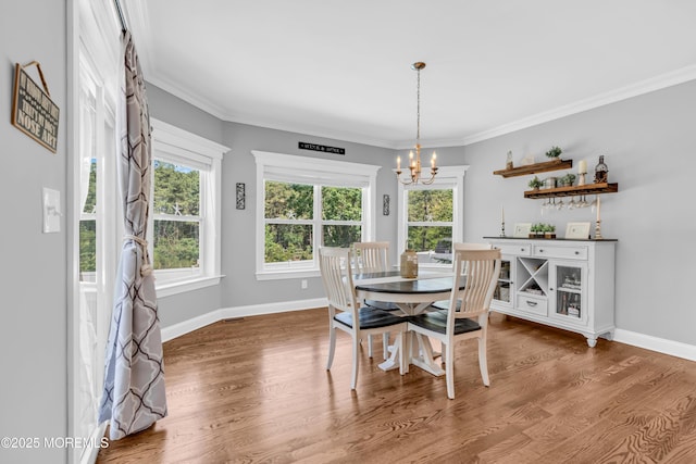 342 Old Squan Rd, Brick, NJ 08724 - dining room featuring a chandelier, wood finished floors, healthy amount of natural light, and crown molding