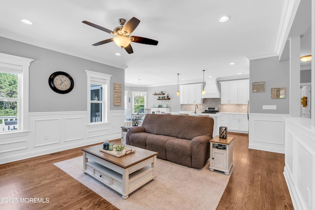 342 Old Squan Rd, Brick, NJ 08724 - living room featuring ceiling fan, a wainscoted wall, ornamental molding, wood finished floors, and recessed lighting