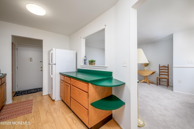 21 Pine Cluster Cir Unit A, Manalapan, NJ 07726 - kitchen with freestanding refrigerator, light wood finished floors, and dark countertops