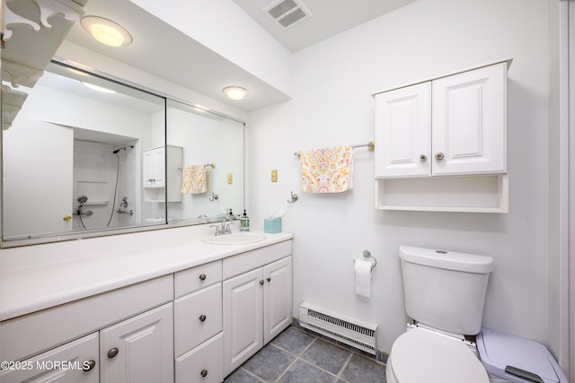 21 Pine Cluster Cir Unit A, Manalapan, NJ 07726 - bathroom with a baseboard heating unit, toilet, vanity, and tile patterned floors