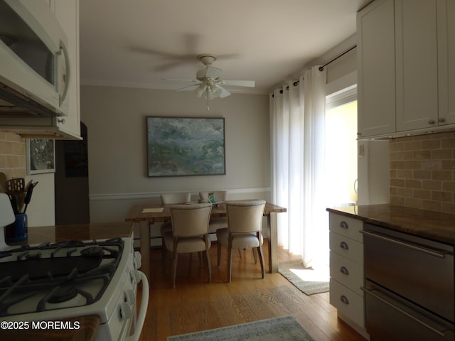 91 Center Ave, Atlantic Highlands, NJ 07716 - kitchen featuring white appliances, ceiling fan, decorative backsplash, light wood-style floors, and crown molding
