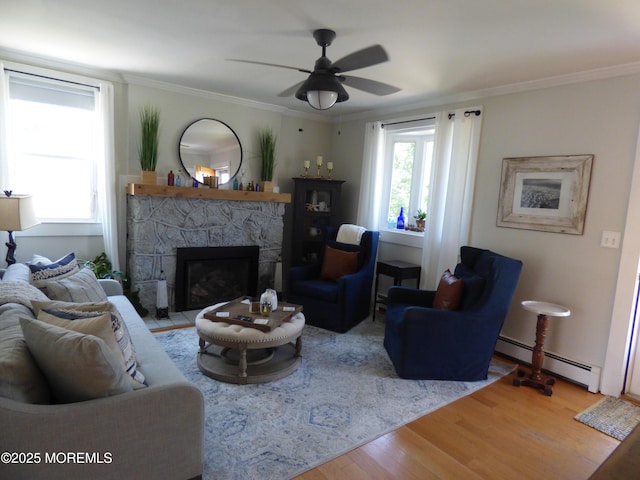 91 Center Ave, Atlantic Highlands, NJ 07716 - living area with a baseboard radiator, wood finished floors, a stone fireplace, ceiling fan, and crown molding