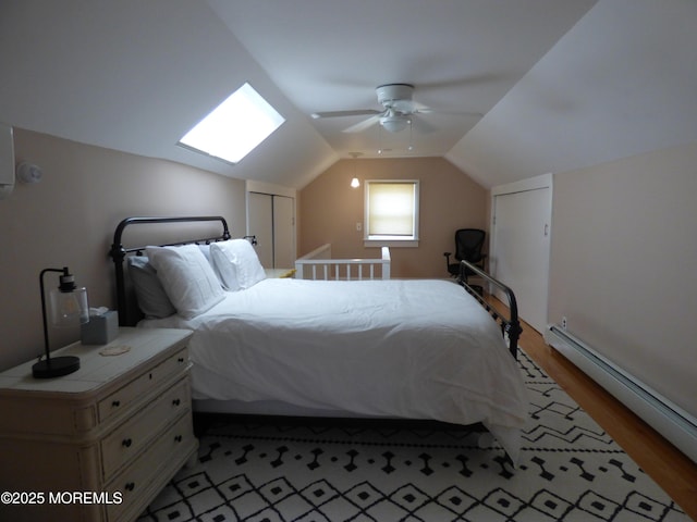 91 Center Ave, Atlantic Highlands, NJ 07716 - bedroom with baseboard heating, light wood-style flooring, vaulted ceiling, and a ceiling fan