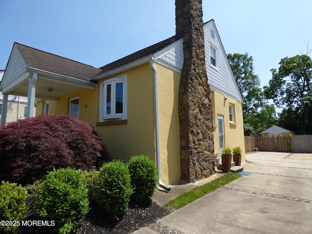 91 Center Ave, Atlantic Highlands, NJ 07716 - view of property exterior featuring stucco siding and a chimney