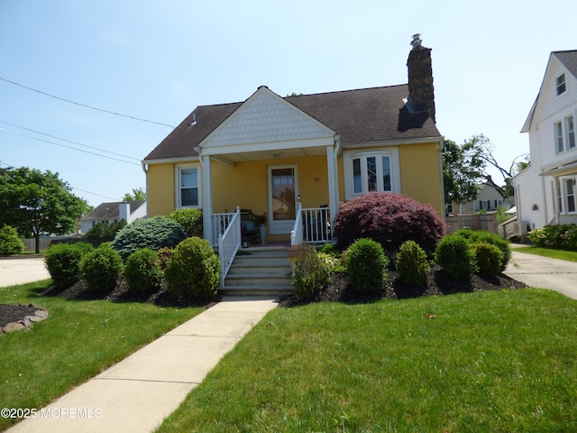 91 Center Ave, Atlantic Highlands, NJ 07716 - bungalow with covered porch, stucco siding, a front yard, and a chimney
