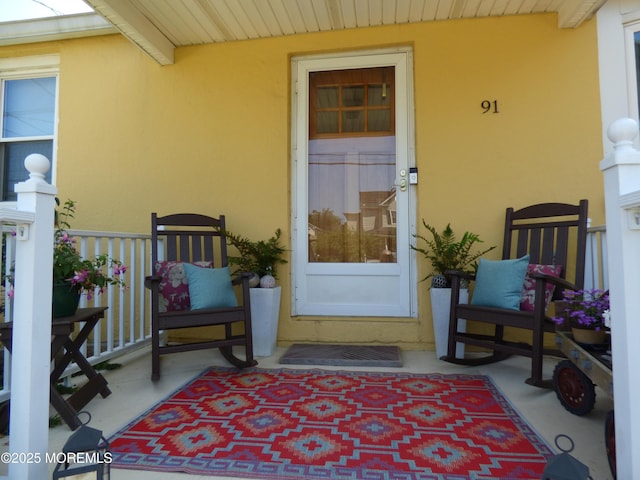 91 Center Ave, Atlantic Highlands, NJ 07716 - view of exterior entry with a porch and stucco siding