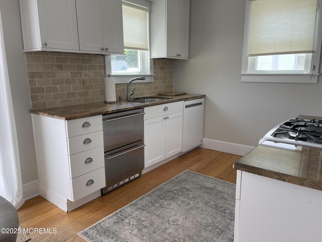 91 Center Ave, Atlantic Highlands, NJ 07716 - kitchen featuring dishwasher, a sink, light wood finished floors, baseboards, and stainless steel dishwasher