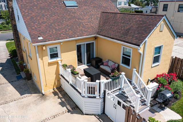 91 Center Ave, Atlantic Highlands, NJ 07716 - rear view of property with roof with shingles, stucco siding, an outdoor living space, and a patio