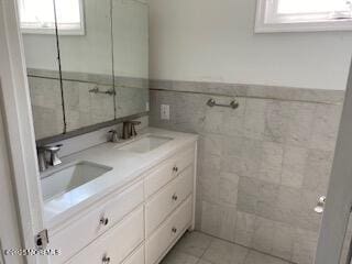 114 Mohican Ln, Little Egg Harbor, NJ 08087 - bathroom featuring double vanity, tile walls, and a wainscoted wall
