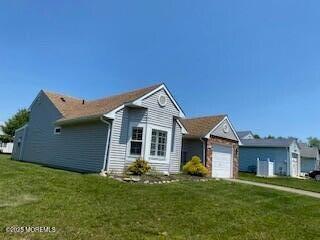 114 Mohican Ln, Little Egg Harbor, NJ 08087 - view of home's exterior featuring an attached garage and a yard