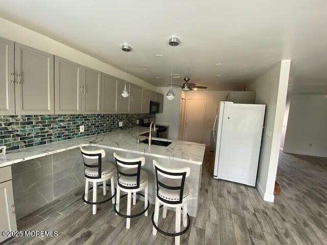 114 Mohican Ln, Little Egg Harbor, NJ 08087 - kitchen featuring freestanding refrigerator, gray cabinets, a sink, wood finished floors, and ceiling fan