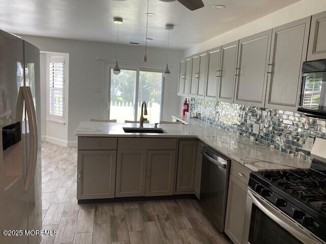 114 Mohican Ln, Little Egg Harbor, NJ 08087 - kitchen featuring stainless steel appliances, a sink, a peninsula, and gray cabinets