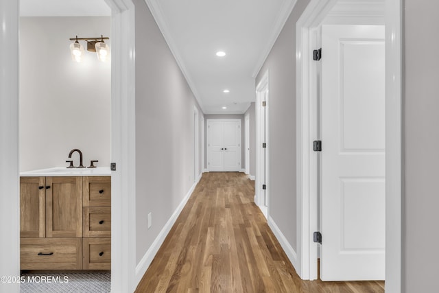 516 13th Ave, Belmar, NJ 07719 - hall with light wood-type flooring, ornamental molding, baseboards, recessed lighting, and a sink
