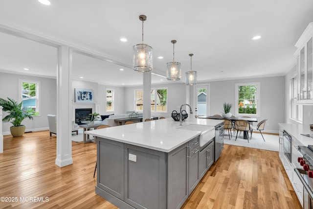 516 13th Ave, Belmar, NJ 07719 - kitchen featuring gray cabinetry, recessed lighting, light countertops, appliances with stainless steel finishes, and a glass covered fireplace