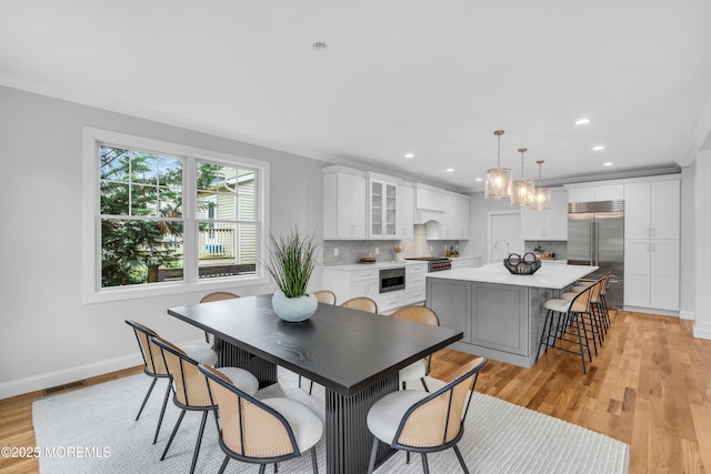 516 13th Ave, Belmar, NJ 07719 - dining space with light wood-type flooring, recessed lighting, ornamental molding, and a chandelier