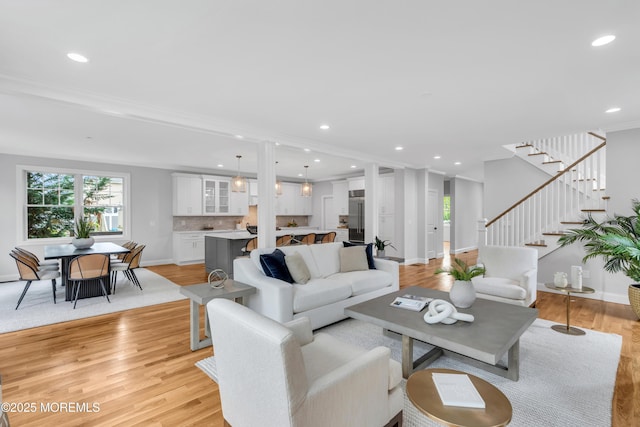 516 13th Ave, Belmar, NJ 07719 - living area with healthy amount of natural light, recessed lighting, stairway, light wood finished floors, and crown molding