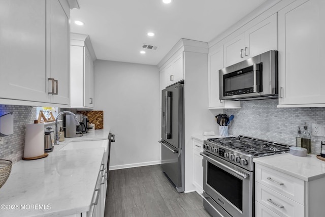 108 Drs James Parker Blvd Unit D8, Red Bank, NJ 07701 - kitchen featuring stainless steel appliances, a sink, backsplash, light stone countertops, and recessed lighting