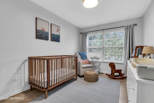 108 Drs James Parker Blvd Unit D8, Red Bank, NJ 07701 - bedroom featuring wood finished floors, baseboards, and a nursery area