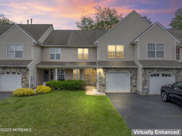 252 Moses Milch Dr, Howell, NJ 07731 - townhome / multi-family property with driveway, an attached garage, a yard, stone siding, and a shingled roof