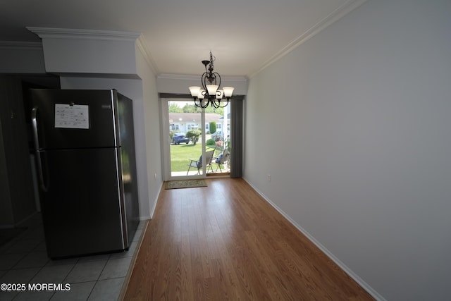 15 Iowa Ct Unit 621, Matawan, NJ 07747 - unfurnished dining area with a chandelier, ornamental molding, and light wood-style floors