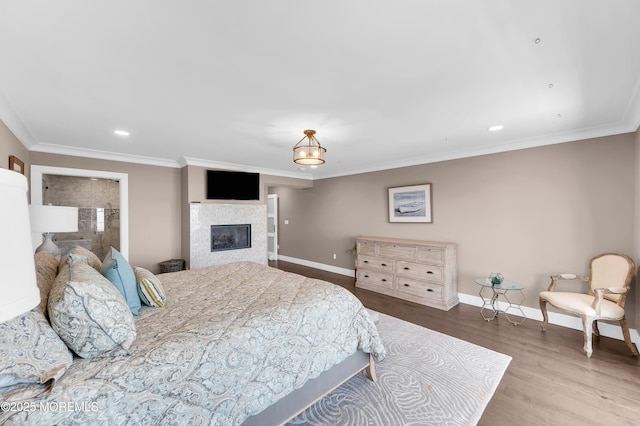 1055 Ocean Ave, Mantoloking, NJ 08738 - bedroom with baseboards, wood finished floors, ornamental molding, a glass covered fireplace, and recessed lighting