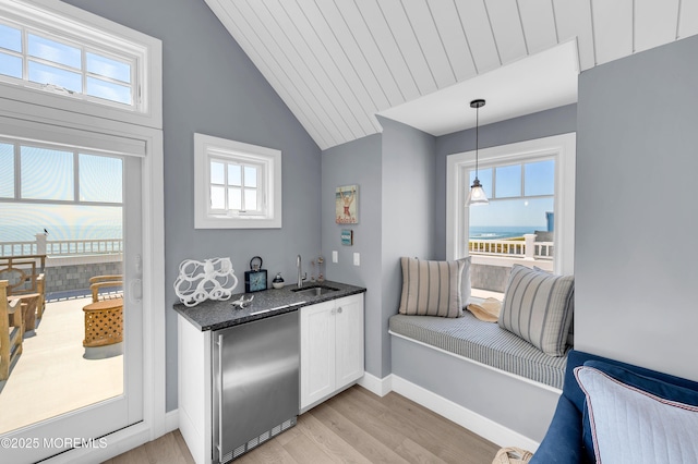 1055 Ocean Ave, Mantoloking, NJ 08738 - kitchen featuring fridge, light wood-style floors, a sink, white cabinets, and vaulted ceiling
