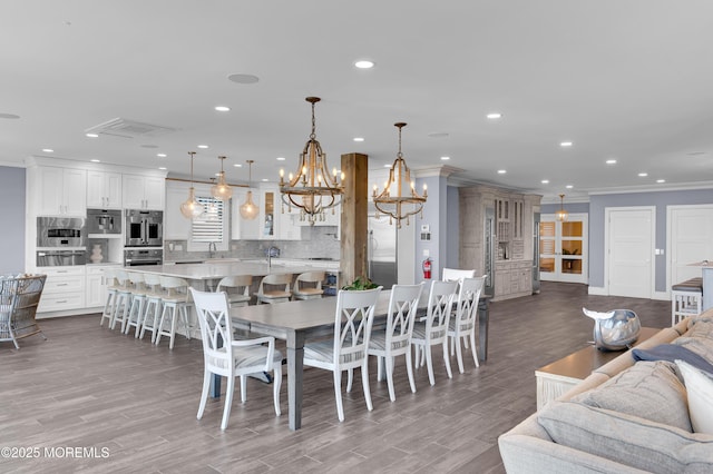 1055 Ocean Ave, Mantoloking, NJ 08738 - dining room with crown molding, a chandelier, wood finished floors, and recessed lighting