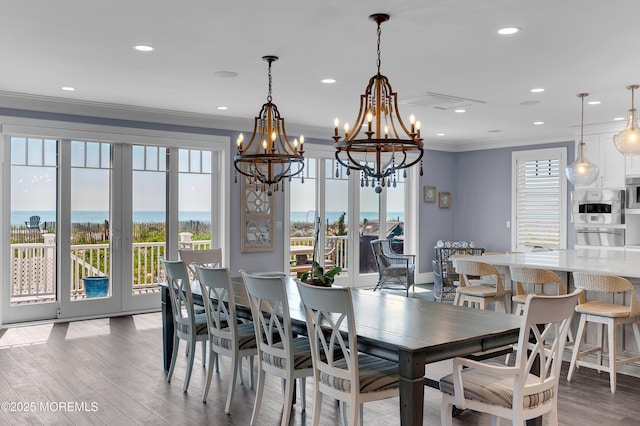 1055 Ocean Ave, Mantoloking, NJ 08738 - dining space with a chandelier, crown molding, wood finished floors, plenty of natural light, and recessed lighting