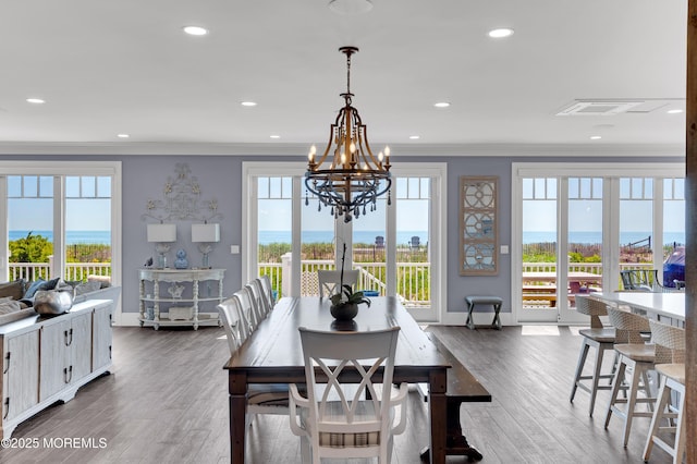 1055 Ocean Ave, Mantoloking, NJ 08738 - dining area with ornamental molding, plenty of natural light, a chandelier, dark wood-style floors, and baseboards