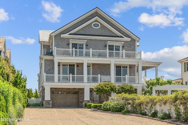 1055 Ocean Ave, Mantoloking, NJ 08738 - view of front of home with a balcony, dirt driveway, and an attached garage