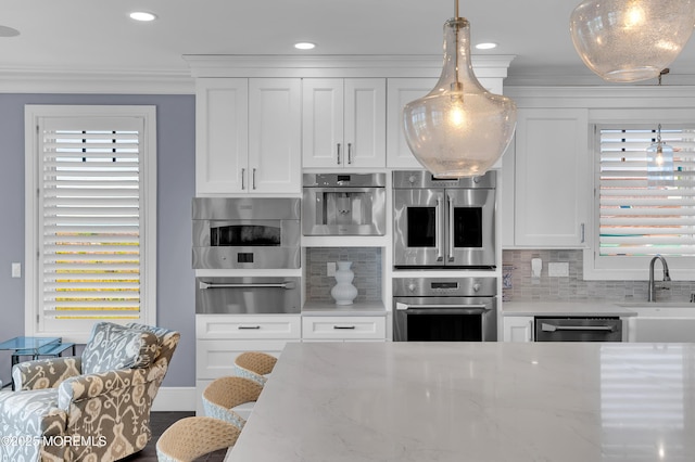 1055 Ocean Ave, Mantoloking, NJ 08738 - kitchen featuring stainless steel appliances, a warming drawer, a sink, decorative backsplash, and white cabinets