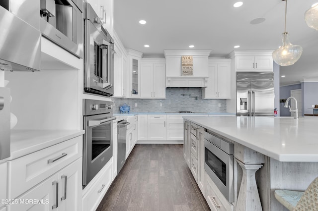 1055 Ocean Ave, Mantoloking, NJ 08738 - kitchen with stainless steel appliances, recessed lighting, light countertops, dark wood finished floors, and backsplash