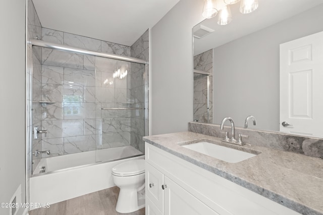 53 Burnt Tavern Rd, Brick, NJ 08724 - bathroom featuring vanity, toilet, wood finished floors, and shower / bath combination with glass door